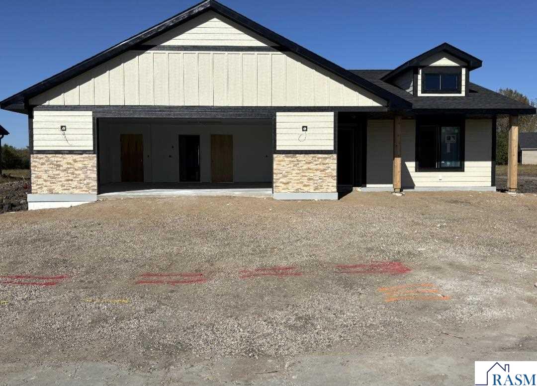 New Construction - 2 bedrooms, 2 bathrooms, oversized 2-stall garage.  Step into modern comfort with this stunning new construction patio home featuring an open-concept layout designed for both relaxation and entertaining. The heart of the home is the spacious living area, complete with a cozy gas fireplace and seamless flow into the kitchen and dining spaces. The kitchen boasts quartz countertops and backsplash, stainless steel appliances, and upgraded finishes throughout, making it as beautiful as it is functional. The primary suite is a true retreat, featuring a private ensuite bathroom with ceramic tile, a walk-in shower, and a generous walk-in closet. The second bedroom and full bath provide comfort and convenience for guests or flexible living space. Enjoy the outdoors on the 12x14 patio, ideal for morning coffee or evening gatherings. Additional highlights include: dual service on-demand water heater with in-floor heat throughout, and a 20x24 pull-up attic space offering exceptional storage. This home delivers low-maintenance living with all the upgrades you’ve been looking for—don’t miss the opportunity to make it your own!