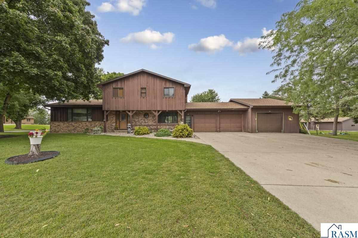 Rare find! This charming Gibbon home sits on a beautiful corner lot just one block from the sunflower fields! This property is an entertainer’s dream providing many living spaces and room for gatherings!  Main level consists of a large family room with a brick fireplace, sunroom, half bath, an open concept living room and completely remodeled kitchen! Remodel boasts new cabinets, center island, countertops, lighting, coffee bar, stainless steel appliances, and much more! This is a must see! Upstairs you will find a primary en suite that includes a spacious primary bathroom with separate shower and jetted tub, double vanity, and multiple closets! Additionally, there are two more bedrooms and an additional full bathroom with a double vanity! Lower level consists of a second family room and laundry/utility room! Outside you find a hexagon patio with built-in swings, fire pit and an additional area under a covered shelter! Perfect for a fall evening! Additional amenities include a three stall attached garage, well-maintained cedar siding, and central air! Schedule your private showing today!