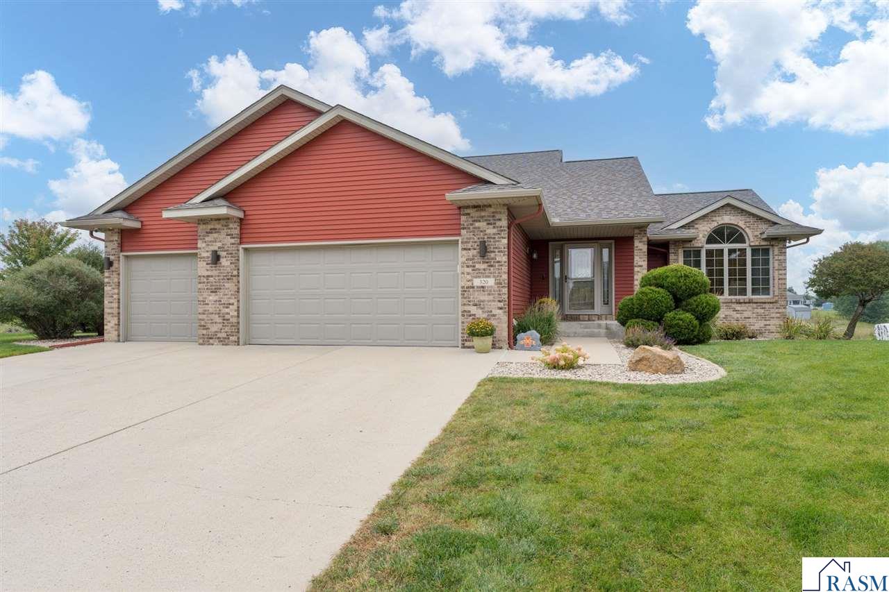Welcome to this spacious 5-bedroom, 3-bathroom home with a 3-stall garage, located on a cul-de-sac. The property features a large fenced backyard and a beautiful lot that backs up to a retaining pond, offering both space and privacy. The main level showcases an open-concept design with kitchen, dining, and living areas that flow together seamlessly. The kitchen includes a large island, stylish finishes, and natural tones, with direct access to a deck that leads down to a patio—perfect for gatherings and entertaining. Upstairs, you’ll find two bedrooms and a full hall bath, along with the primary suite, which includes a private bath with a soaking tub and separate shower. The lower level provides two additional bedrooms, a 3/4 bath, and a spacious family room with a fireplace and built-in cabinetry. The lowest level offers a large rec room, built-in desk, laundry, and abundant storage space. Close to golf course and walking trails. This home combines thoughtful design, functionality, and a fantastic lot setting—ready to welcome its next owners.