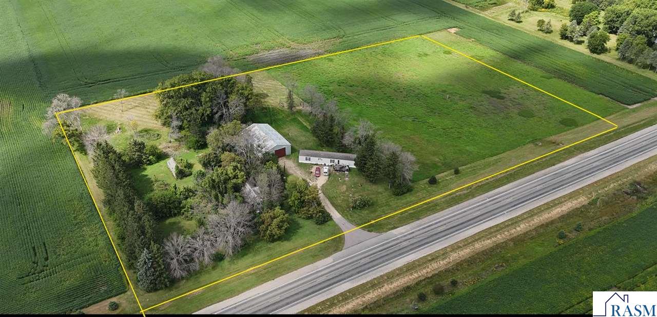 Welcome to your own country retreat on nearly 6 acres, perfectly nestled between Mankato, Good Thunder, and Mapleton. This 5.94-acre property features a home surrounded by mature trees and a wide green yard, offering peaceful country living with convenient access to town. The property includes a pole barn, well house, and plenty of room for gardens, outdoor activities, or gatherings. With ample space to create your ideal hobby farm, recreational getaway, or private retreat, this acreage is ready to be made into your personal paradise. Enjoy the privacy of country life while staying close to city amenities.