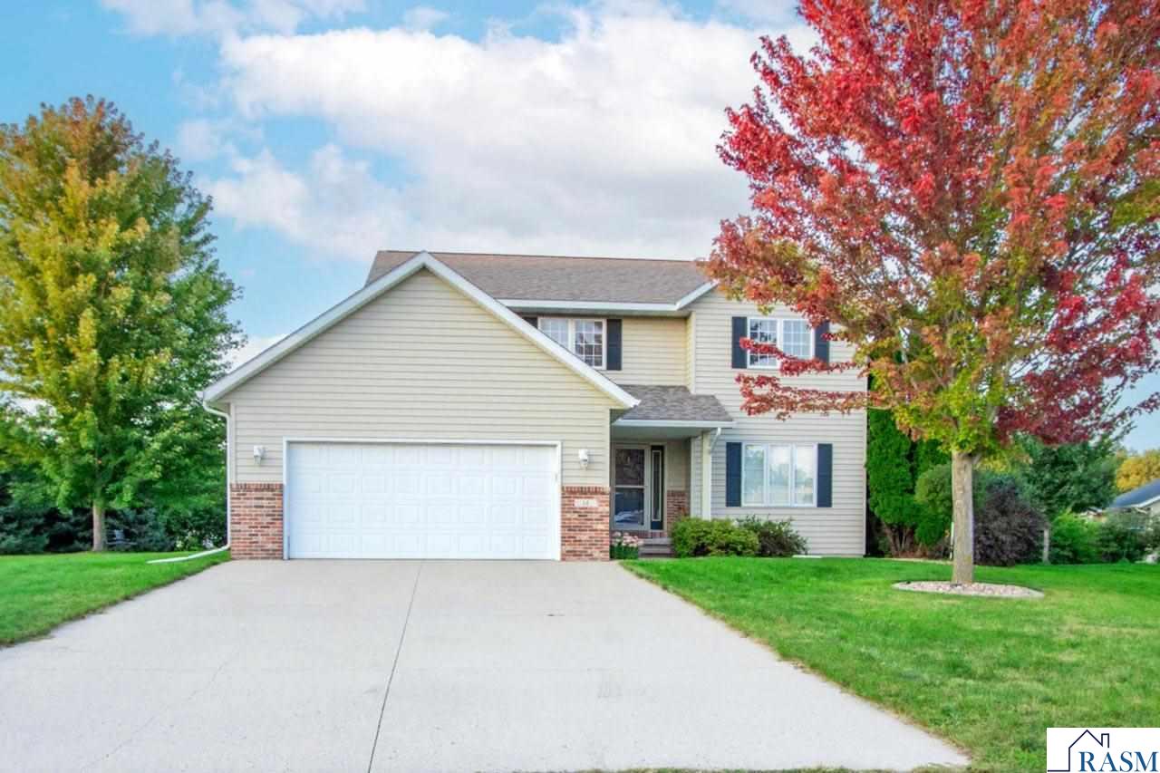 Welcome to this warm and comfortable two-story home, tucked into a peaceful cul-de-sac in Upper North Mankato. As you step inside, you are greeted by the inviting foyer that has beautiful hardwood floors and an entire wall of storage cabinetry, instantly creating the feeling that you are “home.”  Just beyond the foyer is the laundry/mud room complete with handy built-in lockers and access to the oversized double attached garage.  The entirety of the main floor offers a homey layout which is comprised of an inviting living room, French doors to the formal dining room, an informal dining/sitting area, a ½ bathroom and a chefs kitchen complete with granite countertops, classic white subway tile backsplash, a deep farmhouse sink, and modern stainless-steel appliances.   Upstairs, there are four inviting bedrooms, including a peaceful primary suite with its own private bath and a roomy walk-in closet. This level also offers the guest full bathroom, and not to be overlooked; there is a cozy seating area at the top of the stairs!  The completely finished basement forms a warm hangout space with bright LED lighting, custom built-ins and a wet bar.  There is a full bathroom also on this level, as well as the fifth bedroom, the mechanical room, and plenty of storage space! Step outside to enjoy the spacious yard with mature landscaping and continuous cement landscape edging.  Its all complimented by a generous patio; which is perfect for gatherings or quiet evenings. This home is move-in ready and waiting for new memories to be made. Schedule your private showing today!