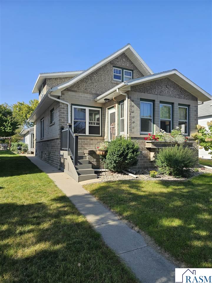 Beautifully cared for home centrally located with a great front porch to enjoy your morning coffee. Inside you'll find a beautiful living room that is open to the kitchen, plus an addition, that added a great dining area, main floor laundry, and a sliding door to access the deck, and that's not all..They also added on a large finished 2 stall garage! Currently there are 3 bedrooms, with an option for a fourth, with an addition of an egress window, and 2 nice bathrooms! In the basement you have a cozy living room with a gas fireplace, and a nice bar area just perfect for entertaining! This is one you do not want to miss.