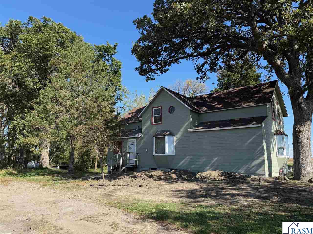If you have been thinking of a small acreage in the country, this is it! Located just off blacktop, on a serene site with plenty of trees and sweeping views of the countryside, this property is ready for new owners to make it their own! Current owners have started some great improvements on this 3-4 bedroom property, and the potential is here for so much more. The main floor offers an entryway, farm-style eat-in kitchen, pantry, living room, laundry room with 1/2 bath, and primary bedroom with large walk-in closet. Upstairs, 3 bedrooms, and a brand new full bath are ready for finishing touches. The full basement features an additional bedroom, rec room, 3/4 bathroom, plenty of storage space, and, it's a walkout!