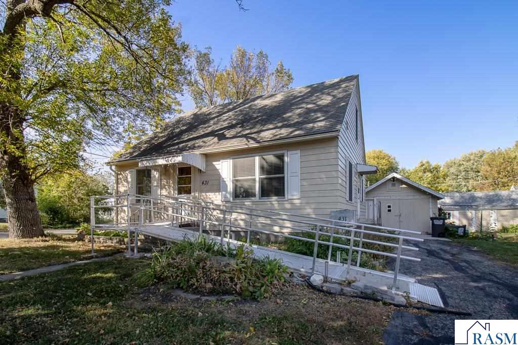 Welcome home to this charming 3-bedroom, 1.5-story home perfectly situated on a corner lot in beautiful Lake Crystal! Thoughtful updates have already been made, including newer windows, refinished hardwood floors, new kitchen flooring, and electrical wiring for a generator. The main level features a bright and functional kitchen with pantry, open dining area, cozy living room, two bedrooms, and a 3/4 bath with added GFCI outlets. Upstairs you’ll find a spacious bedroom with natural woodwork and built-in shelving — full of character and charm. The lower level offers great potential to finish additional living space around the built-in bar and includes a convenient 3/4 bath. Outside, enjoy the partially fenced backyard with a hot tub that stays! The two-stall garage includes a shop area, and there’s even more storage with an additional shed. This home combines comfort, updates, and small-town living — all in one great package.
