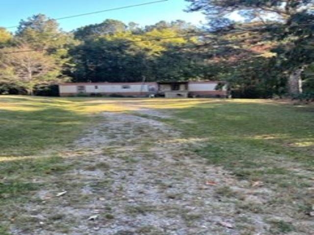 Two acres of land for sale.  Currently, there is a mobile home on the property which we do not have a key for at this time.  Water and electricity are available.