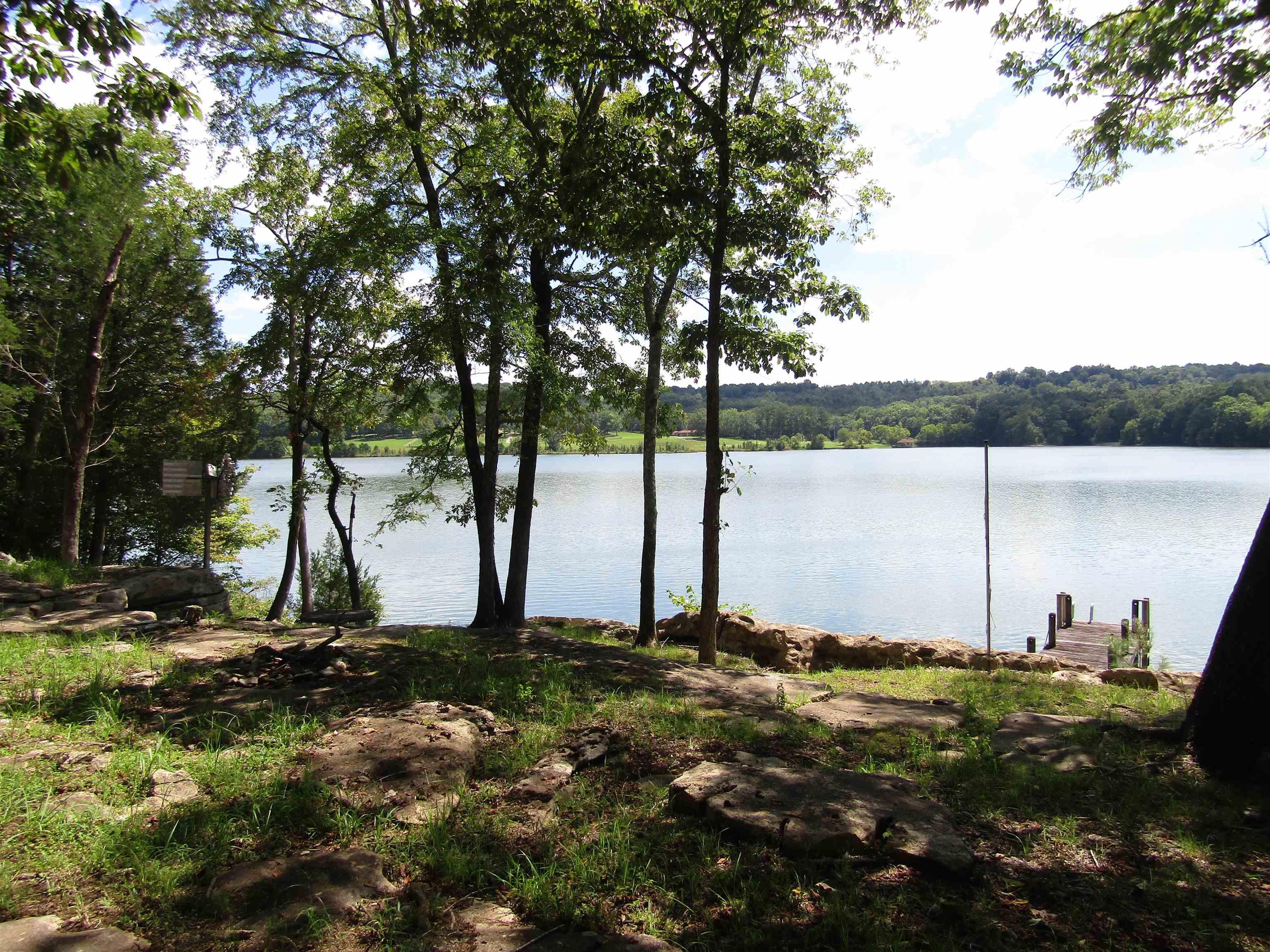 What a view! This 2 bedroom/1bath home located on Cedar Creek Lake offers breathtaking views for its guest.  A wonderful location that boasts a half acre lot on the main lake with plenty of room for entertaining or enjoying a cup of coffee on the front porch.  TVA restrictions and guidelines apply.