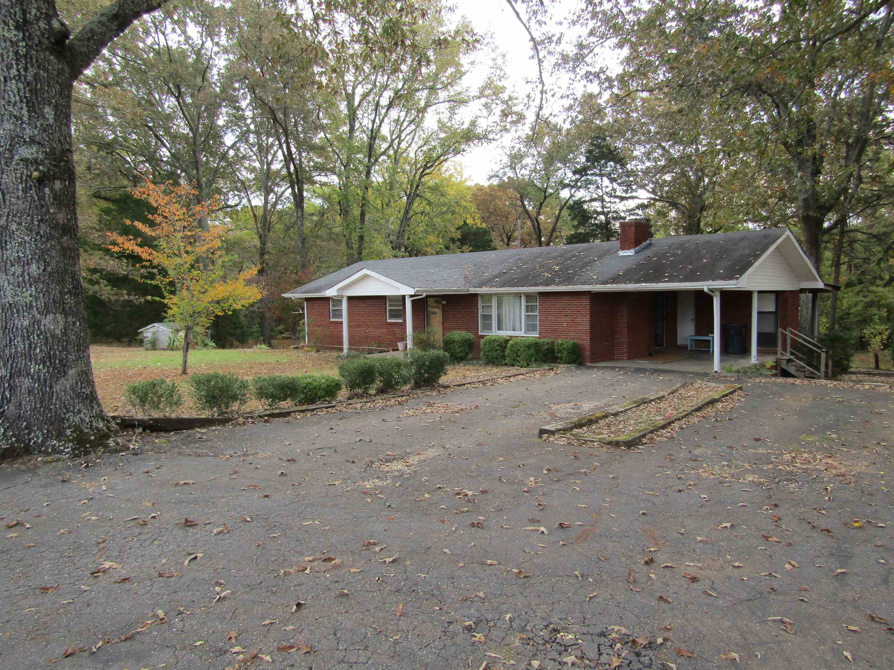 Don't miss your opportunity to own this well built 3 bed 2 bath brick ranch on over 5.3 acres inside the Russellville City Limits.  This home sits on a wonderful heavily wooded lot with several acres of fenced pasture.  There are lots of possibilities with the full unfinished basement.  The back drive features a large two car carport parking area.  There is a shared drive to the pasture and the small barn on the back of the property.  Come see this one before it is too late.