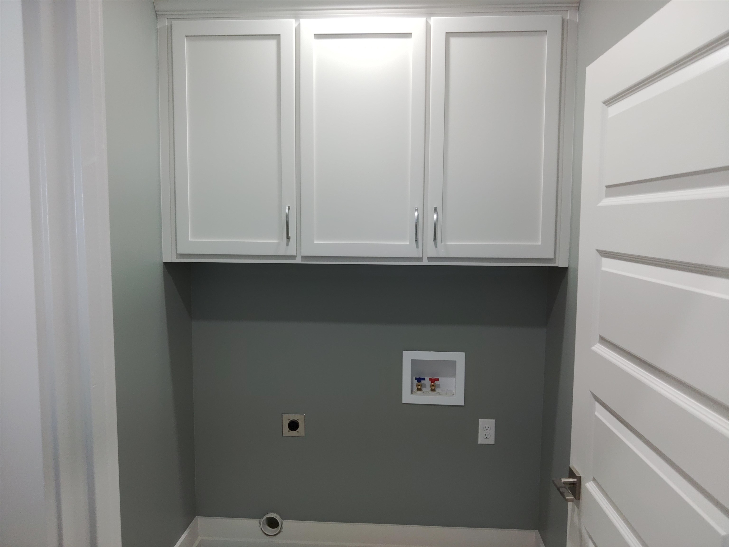Utility room with cabinet storage