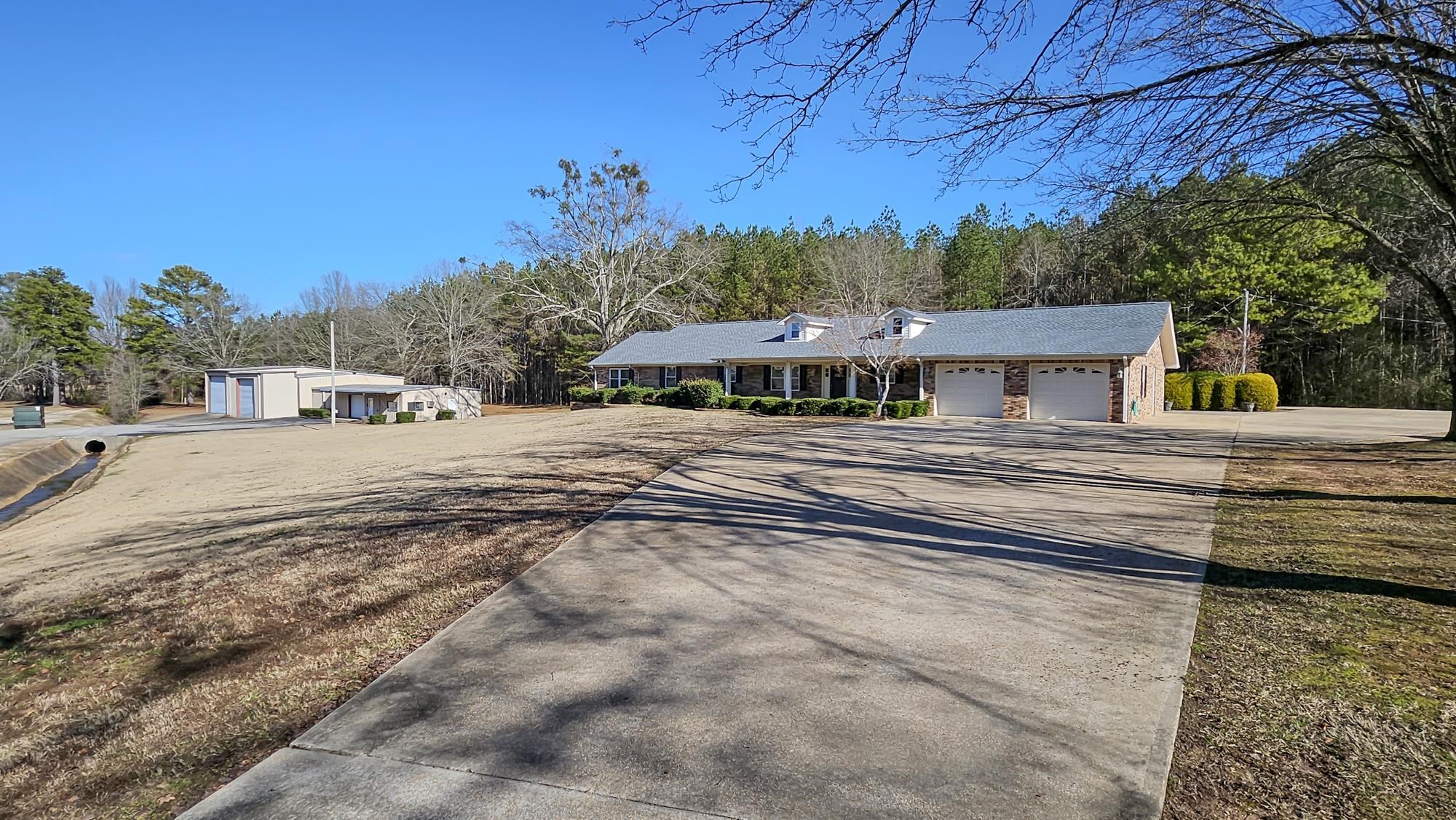Attention GOLFERS! Located directly across from Redmont Country Club on 8+ acres, this property has appx 3000 SF with 3 BR/3 BA and a 3500 SF 3-bay storage bldg with electric roll-up doors big enough to hold LARGE RVs and boats (business opp)! Appx 1300 SF of storage bldg is heated/cooled with office & bath. The house was built in 1985 but almost totally remodeled in 2018 down to stud walls. Primary BR has 3 closets & a connected sitting room w/ wet bar & fridge; BR 2 also has a large connecting room and full bath - great in-law suite with separate entrance. Updates in 2018: New kitchen & bath cabinets w/ quartz counters; convection microwave; flooring; paint; Roof 2024; spray foam insulation in attic; tankless natural gas water heater; crown molding; monitored alarm & smoke detector system; energy efficient windows; F5 tornado safety shelter in garage; gas & electric dry connections; 30&50 amp electric breakers and RV sewer dump;  - too much to put in this listing so come take a look!